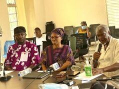 LASSA FEVER: Oyo Govt Confirms 5 Cases, Records 1 Death Diverse group of adults seated around a conference table in a bright room; a man speaks into a microphone while others listen, with notebooks, water bottles, and hand sanitizer on the table.