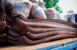 Police Reject ₦100m Bribe, Smash ₦400m Railway Vandal Syndicate Stack of rusted curved metal blades on a truck bed with burlap sacks in the background.
