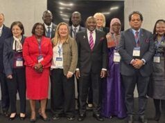 Nigeria Showcases Gains Of Education Reforms At Global Forum Group of diverse professionals wearing conference badges posing for a group photo at a formal event venue.