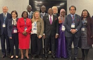 Nigeria Showcases Gains Of Education Reforms At Global Forum Group of diverse professionals wearing conference badges posing for a group photo at a formal event venue.
