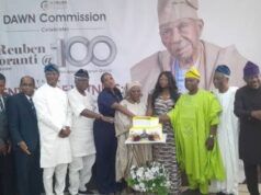 Fasoranti @100: Don Urges Nigerian Leaders To Rise Above Self-Interest, Build Enduring Legacies Group of dignitaries and elders posing with a cake on stage at a Dawn Commission event celebrating Pa Reuben Fasoranti's 100th birthday.