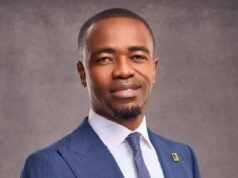 First Bank Strengthens Leadership As Julius Omodayo-Owotuga Joins Board As Executive Director Professional portrait of a man in a blue pinstripe suit, white shirt, and patterned tie, looking at the camera with a calm smile.