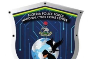 Police Arrest Mother, Daughter Over Alleged N18m Romance Scam Shield-shaped emblem of the Nigeria Police Force National Cyber Crime Center, featuring a globe, an eagle, a hacker silhouette, and circuit motifs.