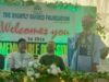 UI Imam Tasks Muslims With Kindness, Good Deeds To Humanity Man in blue traditional attire speaks at a foundation event on a decorated stage; banner behind reads 'The Rightly Guided Foundation welcomes you to this memorable session'.
