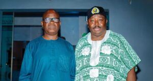 2027: Jubril Dotun Sanusi Hosts Oyo APC Guber Aspirant, Sharafadeen Alli, Discuss Tinubu’s Re-election Plan Two men standing indoors; one wears a blue traditional outfit with glasses, the other a green-and-white patterned agbada with a cap.