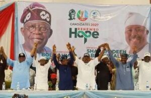 2027: Oyo APC Leaders Adopt Alli As Consensus Governorship Candidate Group of diverse speakers on a stage at a political rally, raising their hands in solidarity in front of a banner that reads 'Renewed Hope' and campaign imagery.
