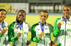 African Senior Athletic Championships: Team Nigeria Wins More Medals Four female athletes in green-and-white jackets hold gold medals, smiling on a track field during an awards ceremony.