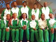 Tinubu Charges Team Nigeria To Excel At World Athletics Relays Group of athletes in matching green and white tracksuits posing for a team photo indoors.