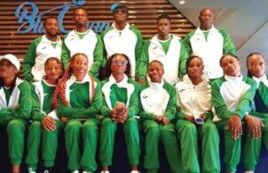 Tinubu Charges Team Nigeria To Excel At World Athletics Relays Group of athletes in matching green and white tracksuits posing for a team photo indoors.