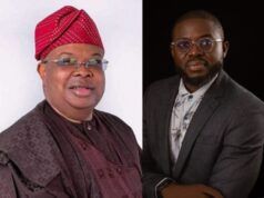 Hassan Giwa Congratulates New Power Minister, Joseph Tegbe Two men seated side by side; left in traditional maroon attire with a red patterned cap, right in a gray suit and glasses.