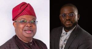 Hassan Giwa Congratulates New Power Minister, Joseph Tegbe Two men seated side by side; left in traditional maroon attire with a red patterned cap, right in a gray suit and glasses.