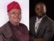 Hassan Giwa Congratulates New Power Minister, Joseph Tegbe Two men seated side by side; left in traditional maroon attire with a red patterned cap, right in a gray suit and glasses.