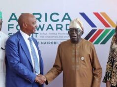 Tinubu Approves Nigeria’s Hosting Of 2026 CAF Congress, Awards Four people stand in front of an Africa Awards backdrop; two men shake hands while the others look on at a formal event in Nairobi.