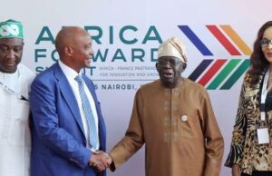 Tinubu Approves Nigeria’s Hosting Of 2026 CAF Congress, Awards Four people stand in front of an Africa Awards backdrop; two men shake hands while the others look on at a formal event in Nairobi.