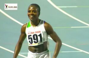 Accra 2026: Amusan Wins Women’s 100m Hurdles Gold Male sprinter wearing bib 591 on a blue track during ACCRA 2026, smiling after a race wear white-green uniform