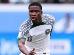 We are here to win the Unity Cup—Tochukwu Nnadi Nigerian national team footballer in white kit with green trim, number 8, sprinting on the field in action.