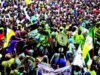 Ojude Oba’ll Be Held Despite Awujale’s Vacant Stool— Organisers Large colorful crowd at a street festival with people dancing and drumming onlookers watching the parade