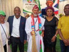 APC-South Africa Inaugurates Mpumalanga Executives, Strengthens Mobilisation For 2027 Election Five people pose at a political event; central man in white robes with a colorful scarf, others in smart attire, APC banner in the back.