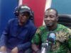 Oyo NUJ Constitutes Committee For 2027 Election Debate Two people sit at a radio studio desk with microphones and headphones, mid-conversation.