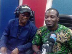 Oyo NUJ Constitutes Committee For 2027 Election Debate Two people sit at a radio studio desk with microphones and headphones, mid-conversation.
