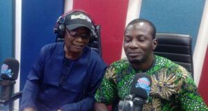 Oyo NUJ Constitutes Committee For 2027 Election Debate, ParrotXtra Media Boss Is Chairman Two people sit at a radio studio desk with microphones and headphones, mid-conversation.