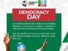 Barr. Akeem Agbaje Reaffirms Support For Tinubu’s Reforms, Honours June 12 Heroes Democracy Day poster with Nigerians raising hands in celebration; green and red panels and text about unity, rule of law, and electoral integrity, plus ADEHUN 2027 APC logos at top.
