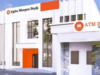 How We Posted ₦1.9 Billion PBT In First 10 Months Of Operations – Alpha Morgan Bank Exterior of an Alpha Morgan Bank branch with white modern facade, orange accents, and an ATM-24/7 service sign.