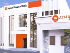 How We Posted ₦1.9 Billion PBT In First 10 Months Of Operations – Alpha Morgan Bank Exterior of an Alpha Morgan Bank branch with white modern facade, orange accents, and an ATM-24/7 service sign.