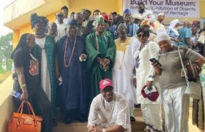 NOA Chief, Kayrom Lee Charge Musicians To Emulate Barrister’s Legacy Large group of people in colorful traditional African clothing posing on steps at an outdoor event.