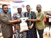 Dangote Foundation Distributes Rice To Cement Host Communities In Ogun L-R: Head of Operations, Aliko Dangote Foundation, Victor Ejiro; a beneficiary, Maria Odutola; Oba Rotimi Mulero, the Aboro of Ibeseland; a beneficiary, Adijat Ogunji and Group Head, Social Performance, Dangote Cement Plc, Wakeel Olayiwola during the distribution of 10KG Bags Of Rice to the Host Communities of Dangote Cement Plc Ibese Plant, as part of Aliko Dangote Foundation's 2026 National Food Intervention Programme…