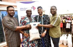 Dangote Foundation Distributes Rice To Cement Host Communities In Ogun L-R: Head of Operations, Aliko Dangote Foundation, Victor Ejiro; a beneficiary, Maria Odutola; Oba Rotimi Mulero, the Aboro of Ibeseland; a beneficiary, Adijat Ogunji and Group Head, Social Performance, Dangote Cement Plc, Wakeel Olayiwola during the distribution of 10KG Bags Of Rice to the Host Communities of Dangote Cement Plc Ibese Plant, as part of Aliko Dangote Foundation's 2026 National Food Intervention Programme…