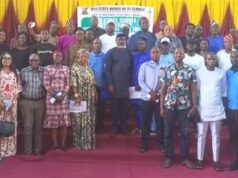Oyo Assembly Assures Cleaner, Healthier Environment As Public Hearing On Single-Use Plastics Prohibition Bill Holds Group of men and women posing on a stage at a formal assembly event, with a banner in the background and yellow/red drapery behind them.