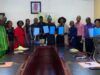 Boost For Students’ Training/Innovation: FCA Ibadan Signs Strategic Agribusiness Partnerships Group of professionals around a conference table holding blue folders, suggesting a signing or agreement ceremony.