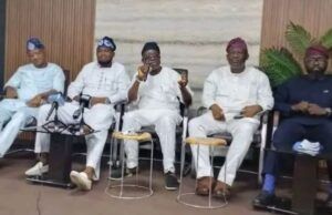 Guber 2027: Five Aspirants Call For Oyo APC Chairman’s Resignation Five men seated in a row at a conference, one speaking into a microphone while others listen, in traditional outfits with neutral backdrop.