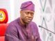 Pity Fayose, Pray For Him, Makinde Tells Nigerians Man in a purple traditional outfit and cap speaks into a microphone at a formal meeting, seated behind a desk with pens in his chest pocket.