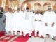 2026 Democracy Day: Be Hopeful For Peace, Unity; Clerics Urge Nigerians Group of men in white traditional robes and caps standing on a red prayer rug inside a mosque, some with hands raised in prayer.
