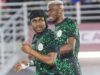 “Come To Galatasaray,” Osimhen Urges Lookman Two Nigerian football players in green and black patterned jerseys celebrate on the pitch during a match.
