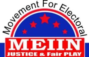 MEIIN Celebrates Democracy Day, Praises Tinubu’s Role In Nigeria’s Democratic Struggle Logo for Movement For Electoral Integrity In Nigeria (MEIN): circular emblem with a red banner reading 'JUSTICE & FAIR PLAY', blue field with red stars, and Nigerian flag colors around the edge.