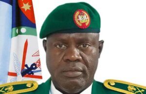 Nigeria-U.S. Partnership Has Weakened ISIS Operations – DHQ Portrait of a green-uniformed military officer with a beret, ribbons, and medals, standing before a flag backdrop.
