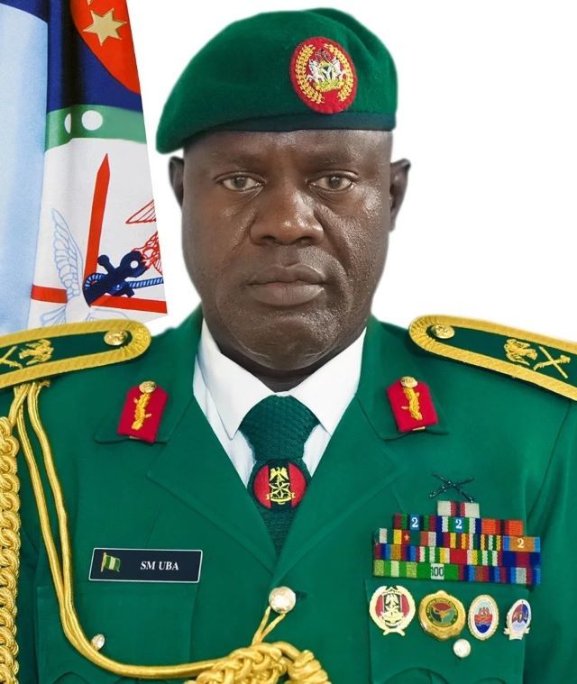 Maj.-Gen. Samaila Uba Portrait of a green-uniformed military officer with a beret, ribbons, and medals, standing before a flag backdrop.