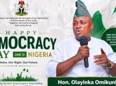 Democracy Day: Hon. Omikunle Celebrates Nigeria’s Heroes, Prays for Peace In The Nation Banner for Nigeria's Democracy Day with a man in traditional attire speaking into a microphone; text reads 'Happy Democracy Day Nigeria June 12' and 'Our Voice. Our Right. Our Future.' with Nigerian flag visuals and 'Hon. Olayinka Omikunle' on a green badge.
