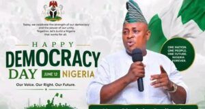 Democracy Day: Hon. Omikunle Celebrates Nigeria’s Heroes, Prays for Peace In The Nation Banner for Nigeria's Democracy Day with a man in traditional attire speaking into a microphone; text reads 'Happy Democracy Day Nigeria June 12' and 'Our Voice. Our Right. Our Future.' with Nigerian flag visuals and 'Hon. Olayinka Omikunle' on a green badge.
