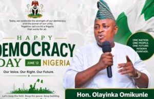 Democracy Day: Hon. Omikunle Celebrates Nigeria’s Heroes, Prays for Peace In The Nation Banner for Nigeria's Democracy Day with a man in traditional attire speaking into a microphone; text reads 'Happy Democracy Day Nigeria June 12' and 'Our Voice. Our Right. Our Future.' with Nigerian flag visuals and 'Hon. Olayinka Omikunle' on a green badge.