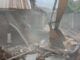 Makinde’s Govt Demolishes Building Used By Kidnappers Of Adelabu’s Sister, Nephews Excavator bucket amid collapsed brick walls and scattered debris at a demolition site with dust in the air.