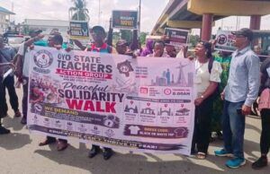 Oyo School Abduction: NANS Urges Caution Over Call For Strike As Crisis Deepens Group of protesters holding a banner for a peaceful solidarity walk organized by the Oyo State Teachers Action Group in Nigeria.