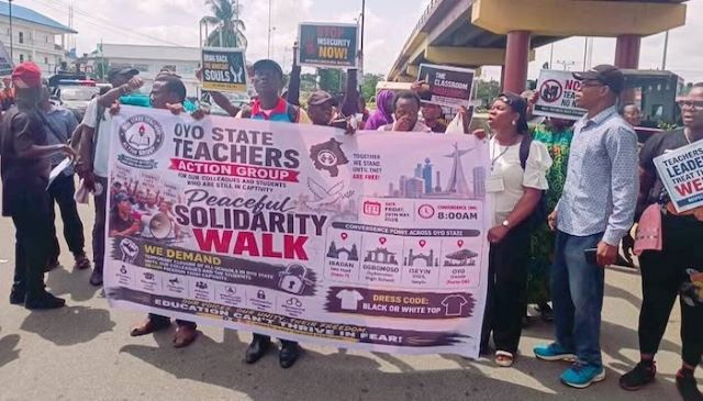 Oyo School strike Group of protesters holding a banner for a peaceful solidarity walk organized by the Oyo State Teachers Action Group in Nigeria.