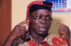 Insecurity: MURIC Urges Southwest Govs To Strengthen Amotekun, OPC Man in a bright shirt and red head wrap gestures with his fingers at his temples, speaking with a serious expression (appears to be making a point).