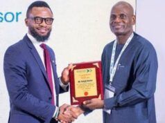 Shell Identifies Strategic Pathways To Advance Gas Utilisation At Abuja Business Forum Two men in business attire shake hands as one presents a wooden plaque award