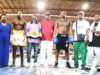 Glorious Promotions Stages ‘Fight Until The Killings Stop’ Boxing Show Group of boxers and coaches posing in a boxing ring; one fighter wears a championship belt across the waist.