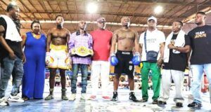 Glorious Promotions Stages ‘Fight Until The Killings Stop’ Boxing Show Group of boxers and coaches posing in a boxing ring; one fighter wears a championship belt across the waist.